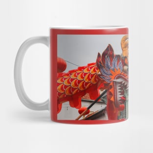 A closeup from the head of a long red dragon in profile Mug